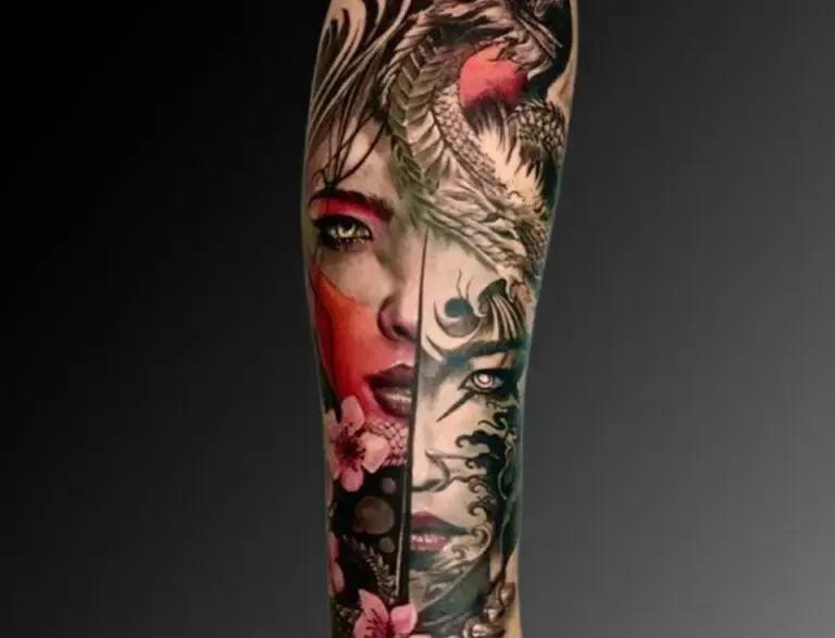 Intricate tattoo covering the forearm, depicting a striking split-face design. One half shows a realistic woman's face in vivid red and pink hues with floral accents, while the other half features a darker, stylized face with tribal and wave-like patterns. A fierce dragon wraps around the top, seamlessly blending the two sides of the design.