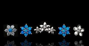 This image showcases a collection of floral-inspired stud earrings featuring sparkling gemstones and vibrant blue opals, set against a sleek black background. Key Features: Floral Designs: Symmetrical flower shapes with clear stones and vivid blue opals as centerpieces. Gemstone Variations: Blue Opals: Two stunning studs with deep, iridescent blue hues. Clear Stones: Elegant sparkle highlighting the floral design. Metal Finishes: Polished silver and gold accents to enhance the gemstone brilliance. Ideal For: Perfect for curated ear styling with floral themes. Versatile fit for lobe, helix, or cartilage piercings. Adding a pop of color or sparkle to any jewelry collection.