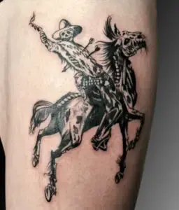 Black ink tattoo of a skeletal cowboy riding a skeletal horse. The cowboy is wearing a wide-brimmed hat, holding a lit torch in one hand, and has arrows sticking out of his back. The horse appears dynamic, with exaggerated features and a menacing stance, creating a dark, dramatic, and stylized design