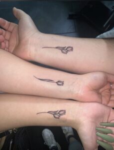 a couple of hands with tattoos