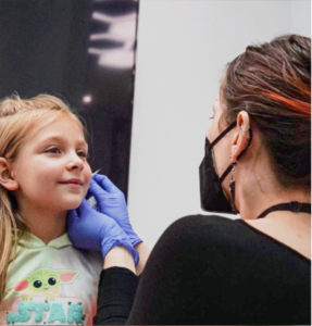 Kid getting ear piercings San Antonio, TX